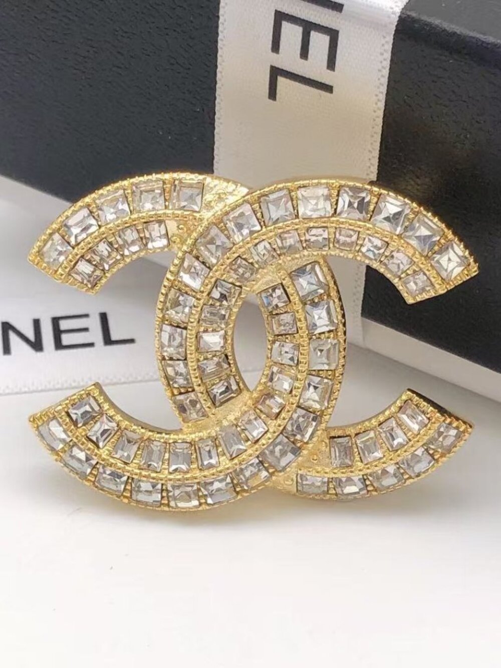 Chanel diamond-encrusted square diamond brooch.